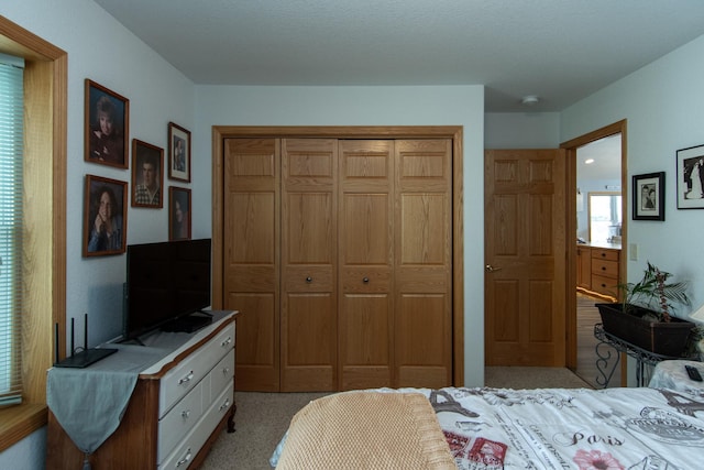 bedroom with a closet and light colored carpet