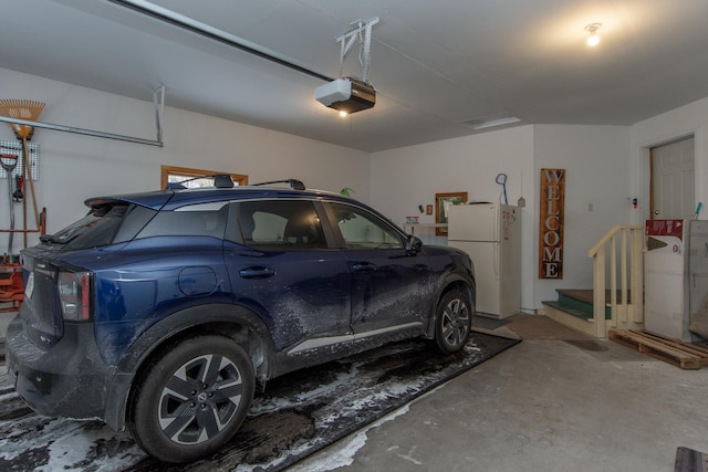 garage with freestanding refrigerator and a garage door opener