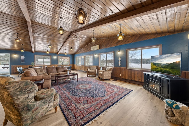 living room with vaulted ceiling, wooden walls, a wall mounted AC, wood ceiling, and light hardwood / wood-style flooring