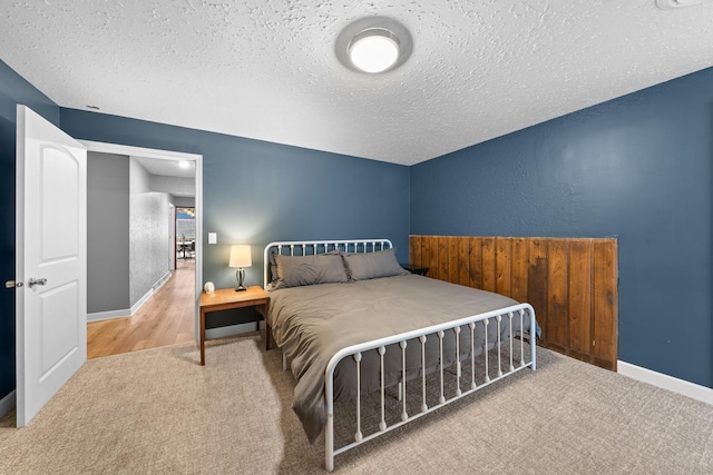 carpeted bedroom featuring a textured ceiling