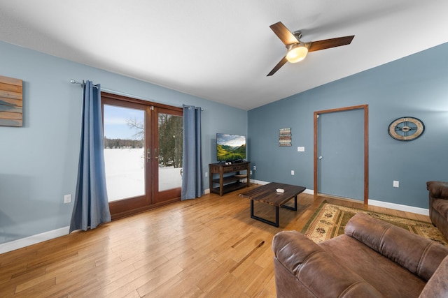 living room featuring french doors, ceiling fan, lofted ceiling, and light hardwood / wood-style flooring