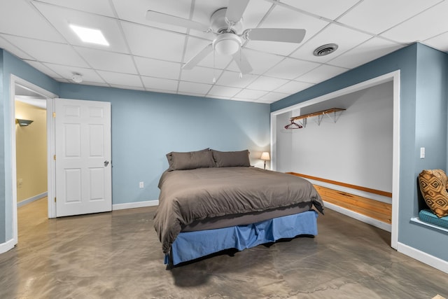 bedroom featuring a drop ceiling and ceiling fan