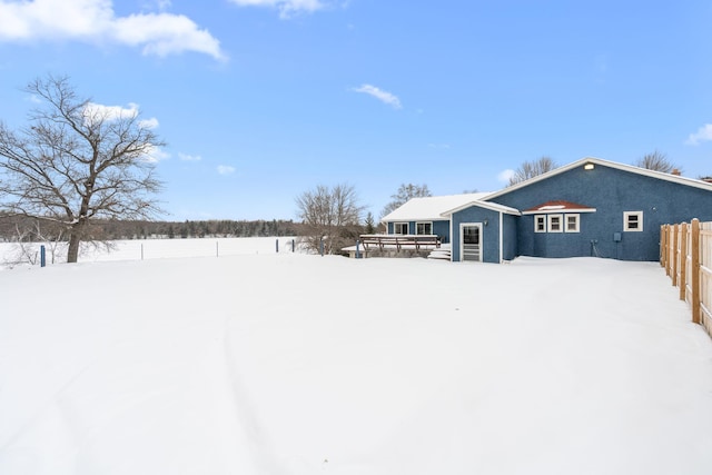 view of snow covered back of property