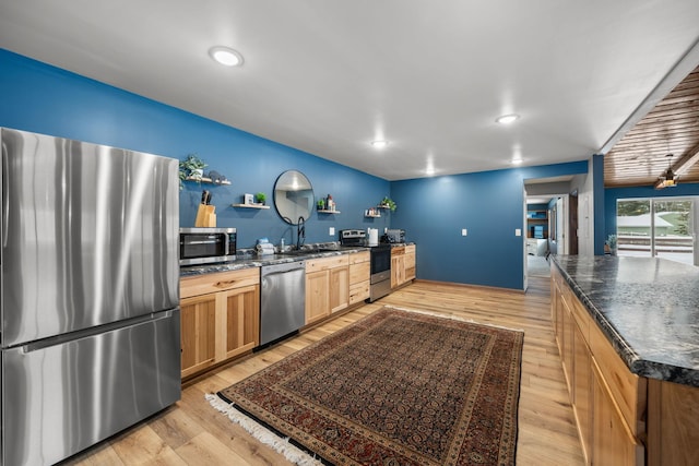 kitchen featuring light brown cabinets, light wood-style flooring, recessed lighting, a sink, and appliances with stainless steel finishes