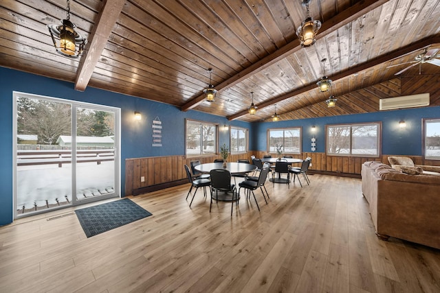 dining area featuring vaulted ceiling with beams, a wainscoted wall, a wall unit AC, and hardwood / wood-style flooring