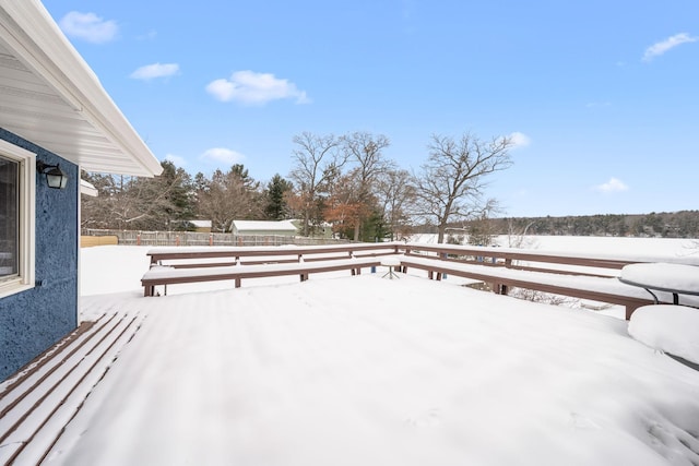 snow covered deck with fence