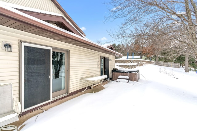 snow covered patio featuring fence