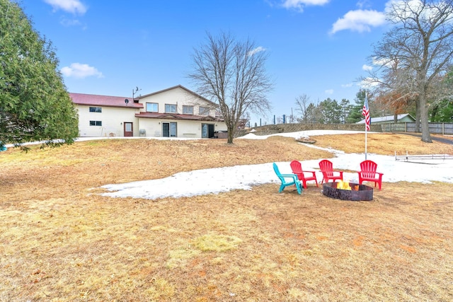 view of yard featuring an outdoor fire pit and fence