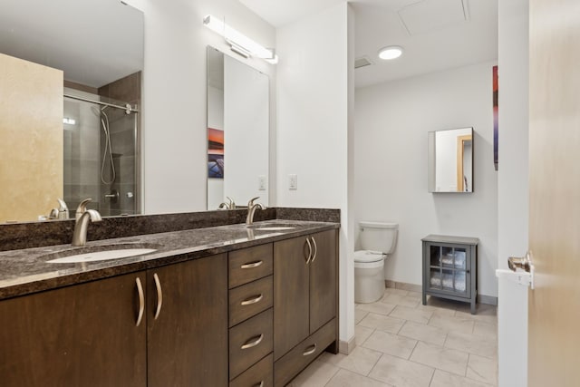 1240 2nd St Unit 704, Minneapolis, MN 55415 - bathroom with toilet, a shower with shower door, double vanity, and baseboards