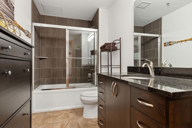 1240 2nd St Unit 704, Minneapolis, MN 55415 - bathroom with toilet, vanity, and bath / shower combo with glass door