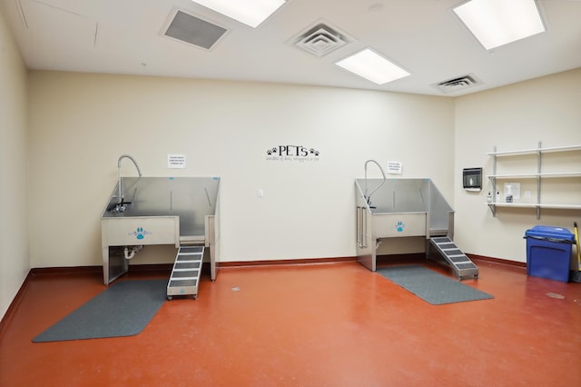 1240 2nd St Unit 704, Minneapolis, MN 55415 - miscellaneous room featuring pet washing station, concrete floors, and baseboards