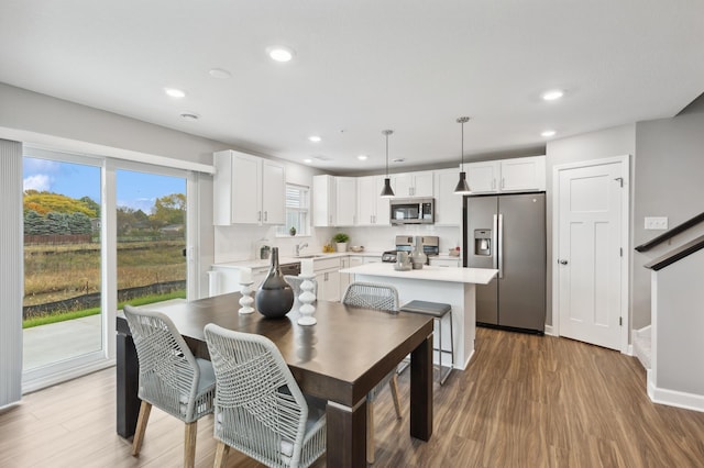 dining area with sink and hardwood / wood-style floors