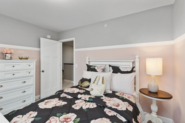 carpeted bedroom with a textured ceiling