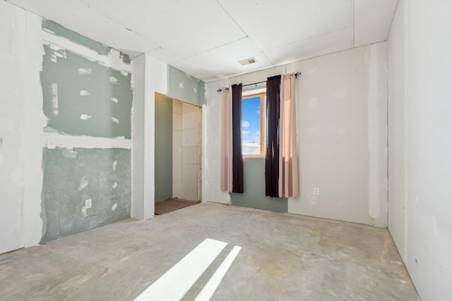 unfurnished room featuring visible vents and unfinished concrete floors