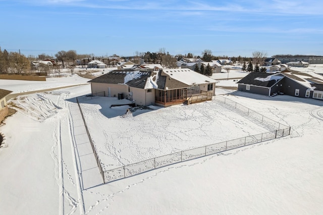 snowy aerial view featuring a residential view