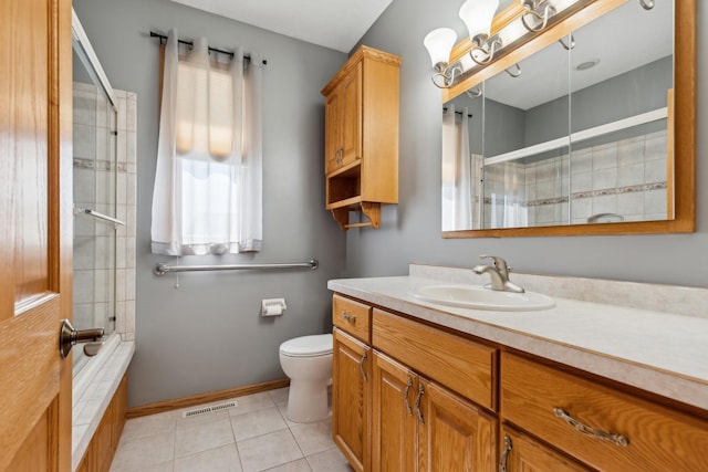 bathroom featuring vanity, visible vents, tile patterned floors, toilet, and tiled shower / bath