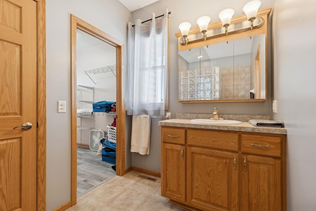 bathroom featuring vanity, tile patterned floors, and baseboards