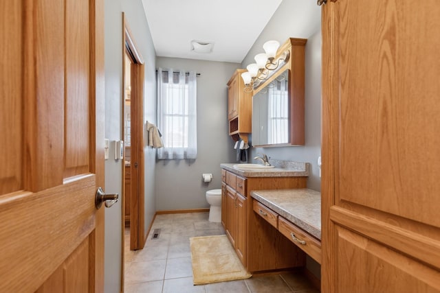 bathroom featuring visible vents, baseboards, toilet, tile patterned floors, and vanity