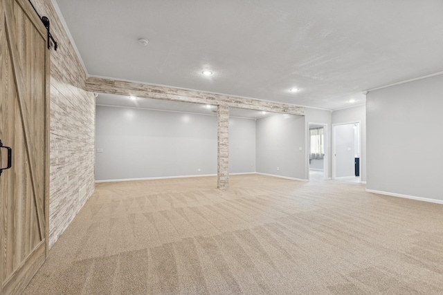 below grade area featuring light carpet, crown molding, and baseboards