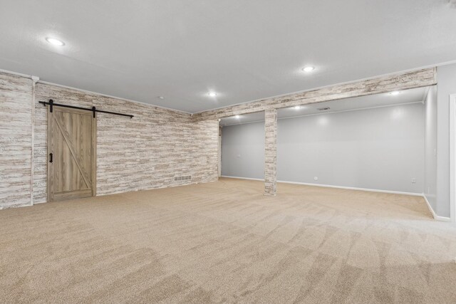 531 Depree Way, Glenwood, MN 56334 - finished basement featuring a barn door, carpet floors, recessed lighting, ornamental molding, and baseboards