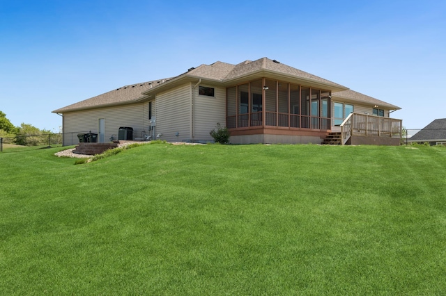 531 Depree Way, Glenwood, MN 56334 - back of property featuring a sunroom, a lawn, central air condition unit, and roof with shingles