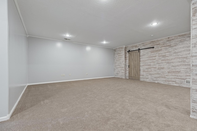 531 Depree Way, Glenwood, MN 56334 - below grade area with a barn door, carpet, baseboards, crown molding, and recessed lighting