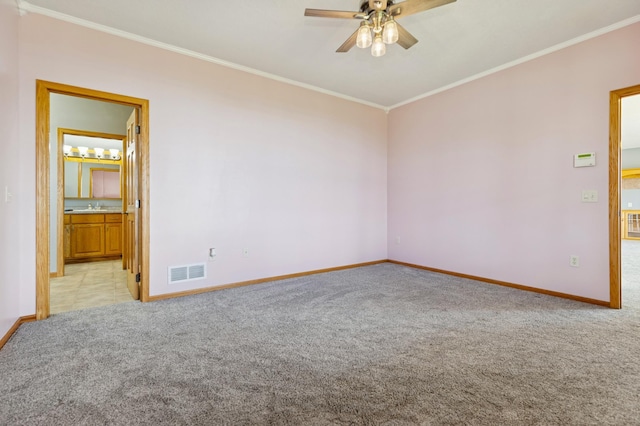 531 Depree Way, Glenwood, MN 56334 - empty room featuring light carpet, ornamental molding, a ceiling fan, baseboards, and a sink