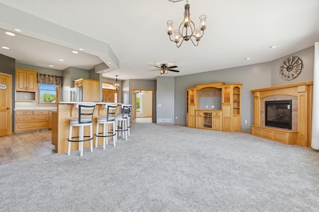 531 Depree Way, Glenwood, MN 56334 - living area with a chandelier, recessed lighting, a fireplace, a ceiling fan, and light carpet