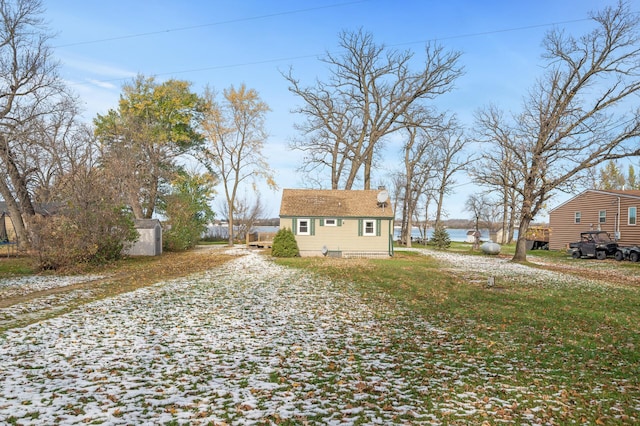 exterior space featuring an outbuilding and a water view