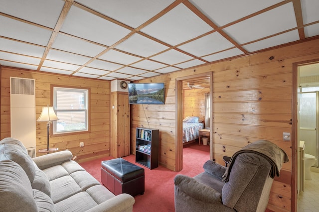 carpeted living room featuring coffered ceiling and wood walls