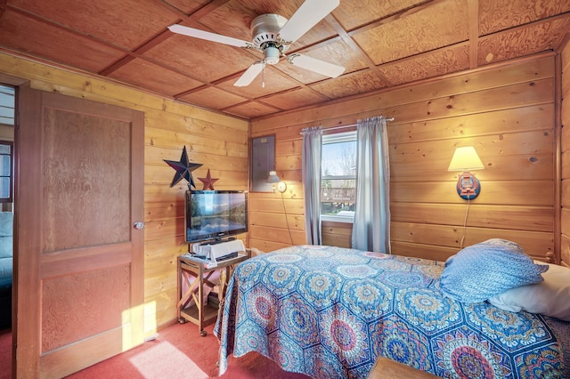 carpeted bedroom with ceiling fan, coffered ceiling, and wooden walls