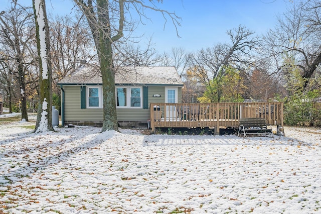 snow covered property featuring a deck