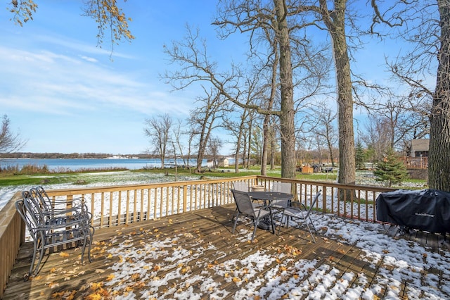 wooden deck featuring a water view and a grill