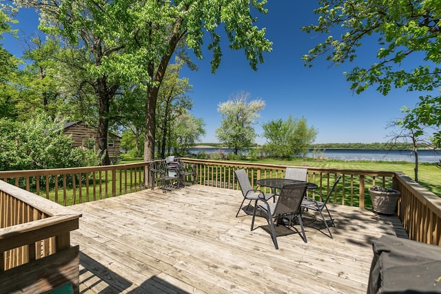 wooden deck featuring a water view and outdoor dining area