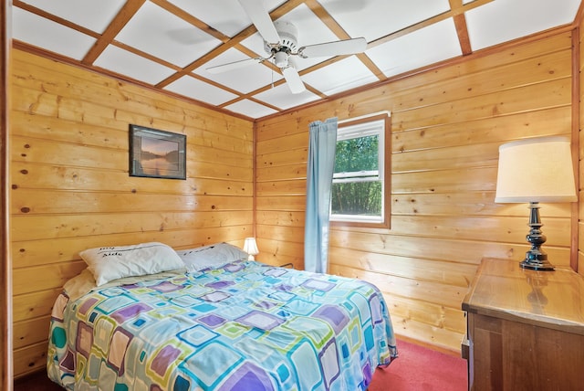 bedroom with wooden walls and a ceiling fan