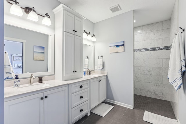 full bathroom with double vanity, visible vents, walk in shower, and a sink