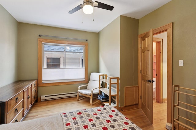 2701 Harriet Ave Unit 200, Minneapolis, MN 55408 - sitting room with light wood finished floors, a ceiling fan, and a baseboard heating unit