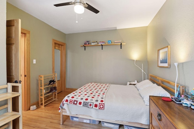 2701 Harriet Ave Unit 200, Minneapolis, MN 55408 - bedroom featuring light wood-style floors, a ceiling fan, and baseboards