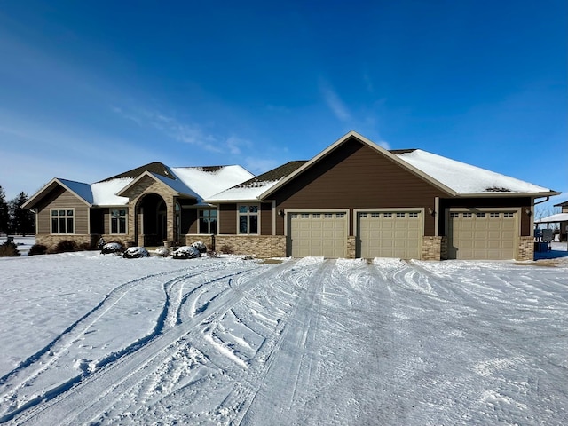 view of front of home featuring a garage and stone siding