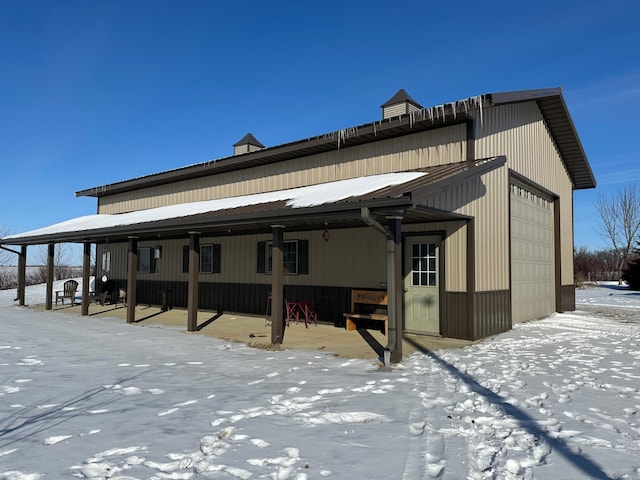 exterior space with a garage and metal roof