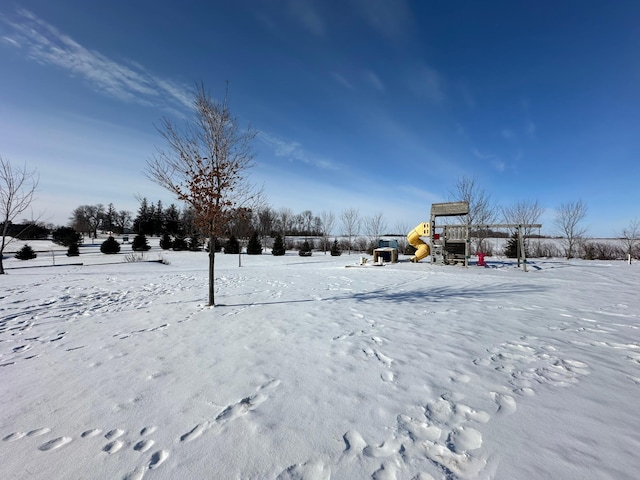 yard layered in snow featuring playground community