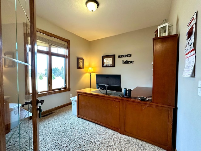 home office with light carpet and baseboards