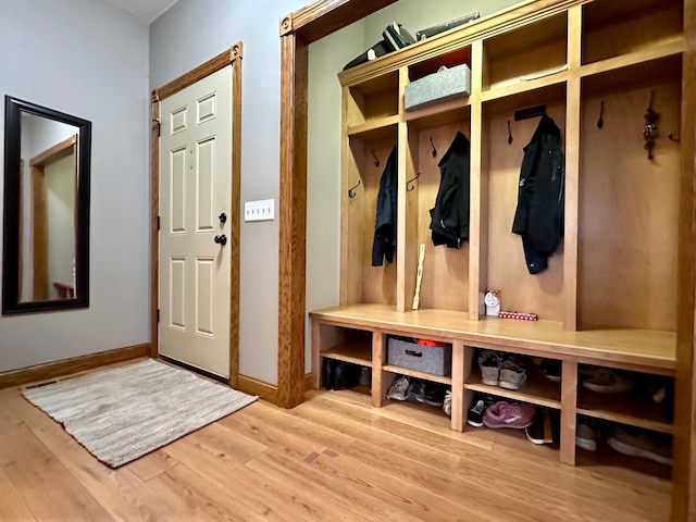 mudroom with baseboards and wood finished floors