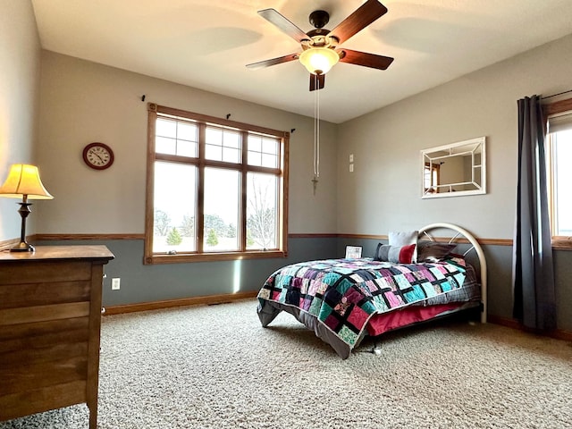 carpeted bedroom featuring ceiling fan and baseboards