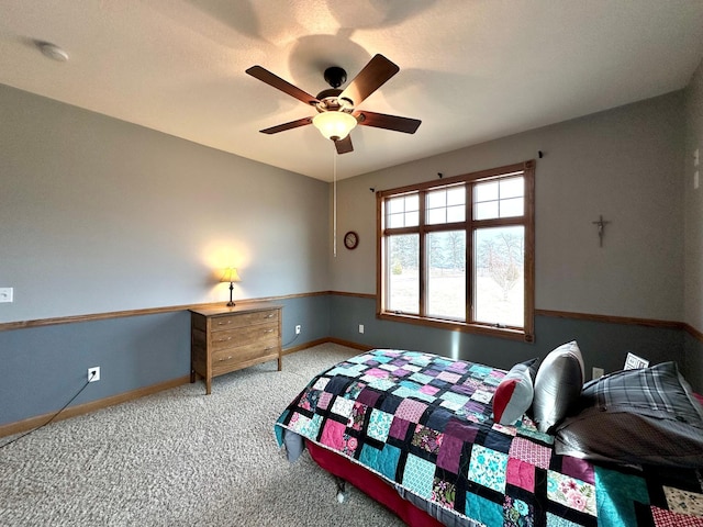 bedroom featuring ceiling fan, carpet flooring, and baseboards