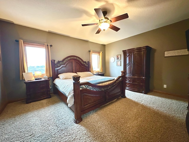 bedroom with light carpet, a ceiling fan, and baseboards