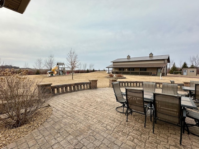 view of patio / terrace featuring outdoor dining area and a playground