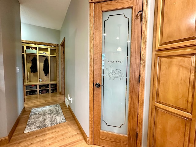 interior space featuring light wood-style flooring and baseboards