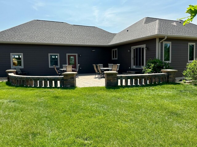13943 Sundberg Ave, Graham Lakes Twp, MN 56131 - rear view of property with a patio, a yard, and a shingled roof
