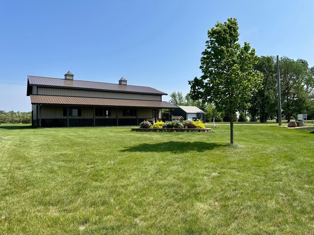 13943 Sundberg Ave, Graham Lakes Twp, MN 56131 - back of house featuring a yard, a chimney, and metal roof